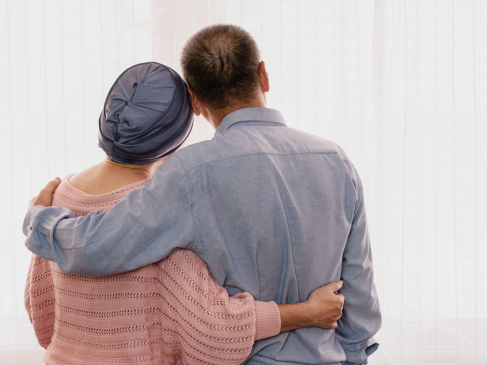 woman-with-head-scarf-cuddled-by-husband-Christopher-case-study Immigration Advice